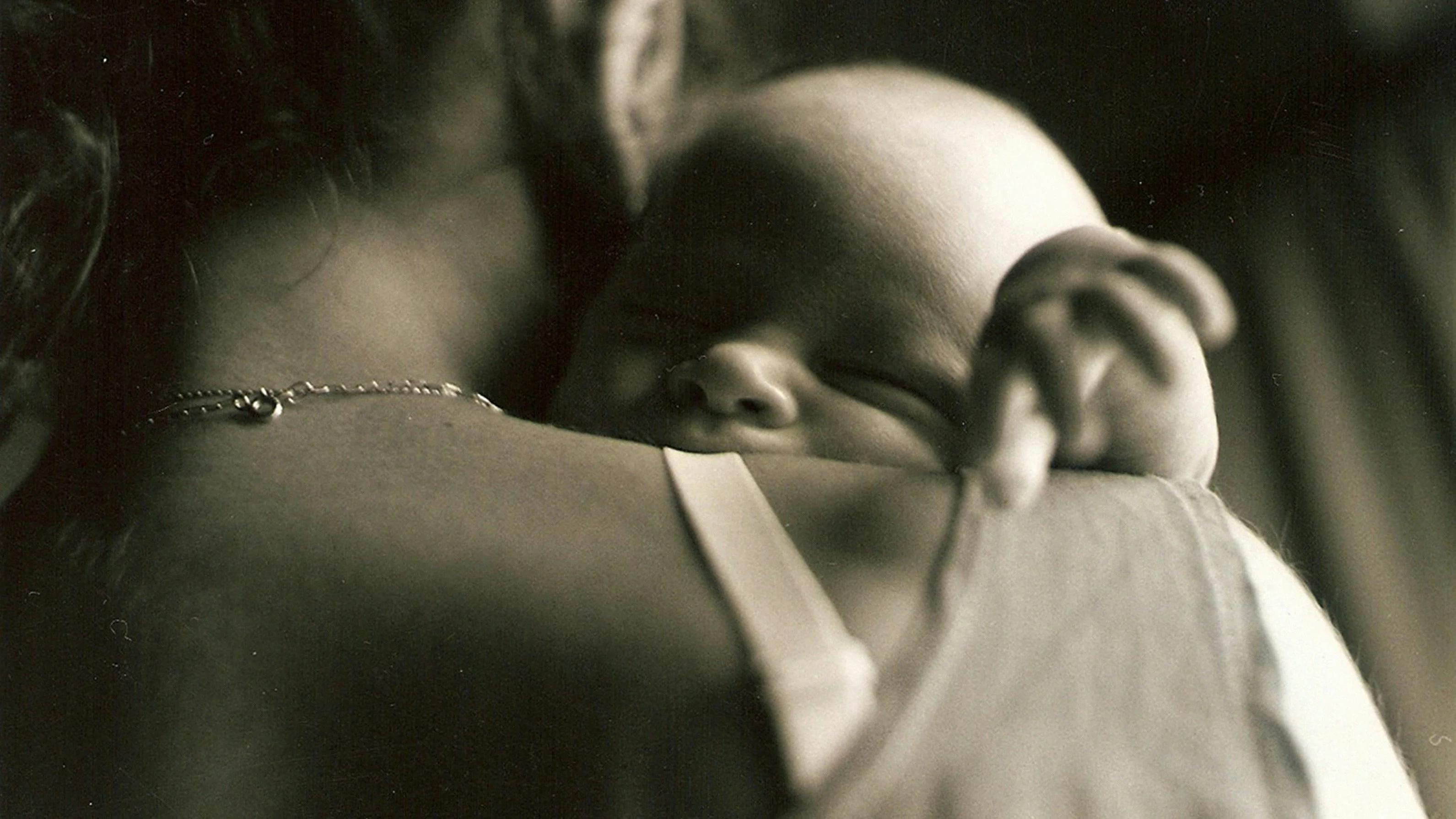 A new mother sitting quietly, lost in thought