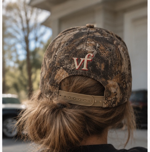 A woman wearing the Mother Hat seen from behind, with her hair in a low bun through the back